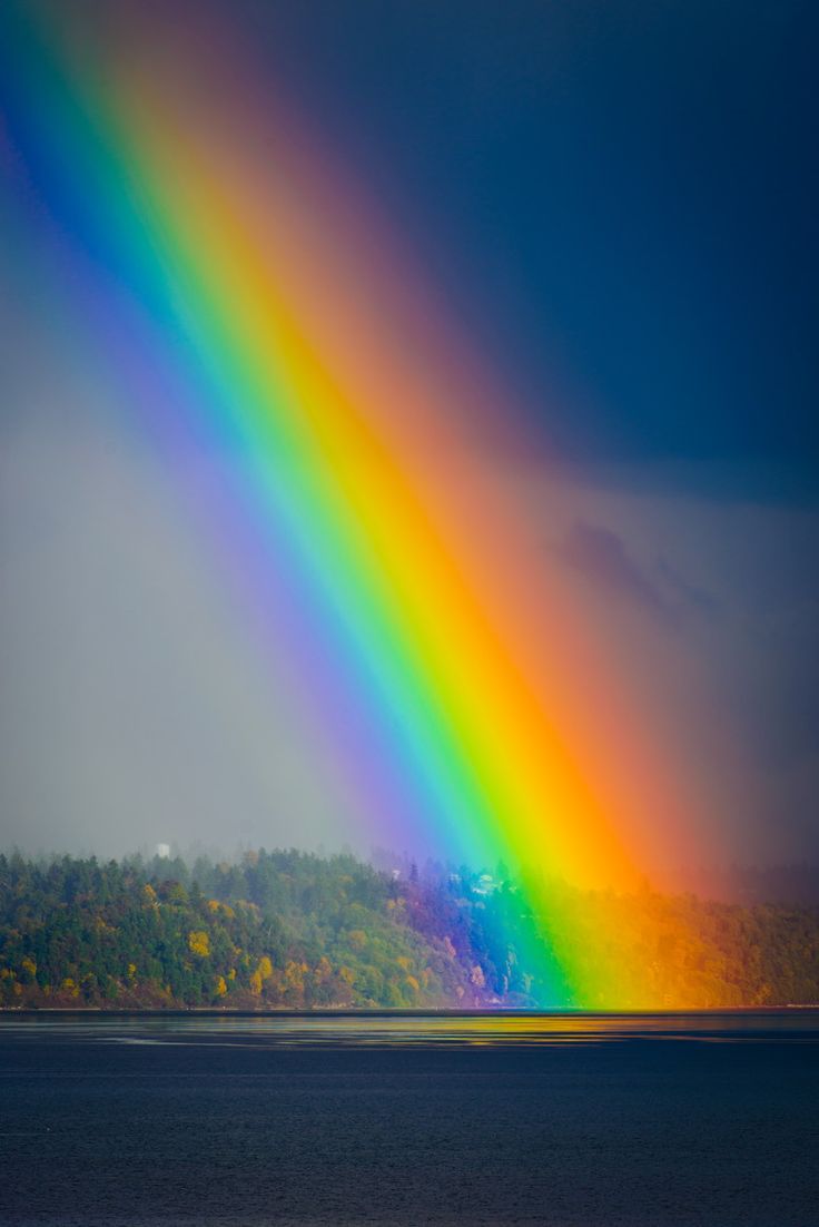 Rainbow ending in Tramp Harbor in the Puget Sound near West Seattle, Washington, USA